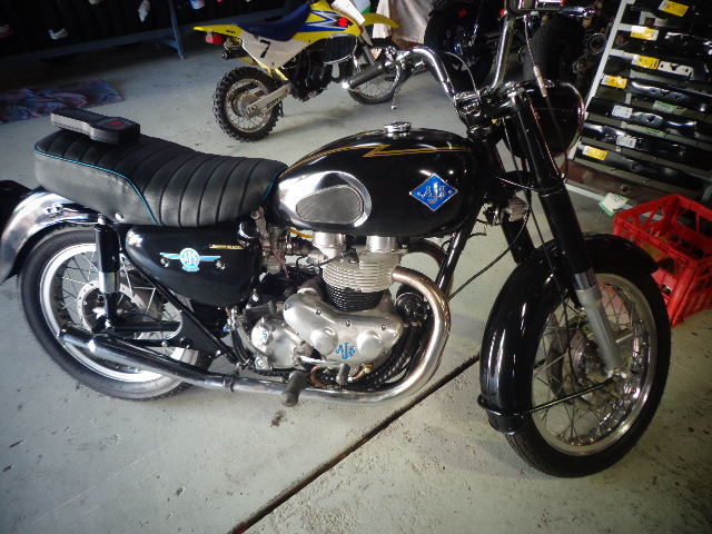 A restored black BSA motorcycle with a chrome tank panel and blue pinstriping